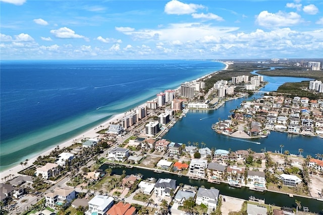 birds eye view of property with a water view, a beach view, and a city view