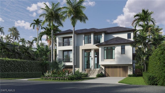 view of front of property featuring a garage, driveway, and stucco siding