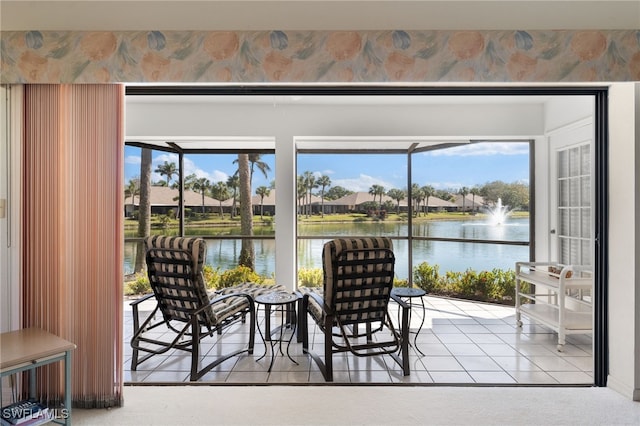 doorway with tile patterned floors and a water view