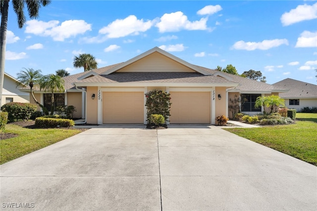 ranch-style home with a garage and a front yard