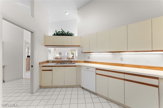 kitchen featuring dishwasher, sink, and cream cabinetry