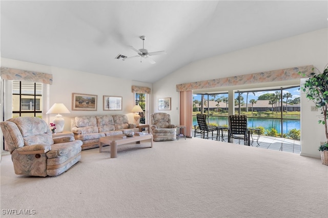 carpeted living room featuring a water view, ceiling fan, vaulted ceiling, and a wealth of natural light