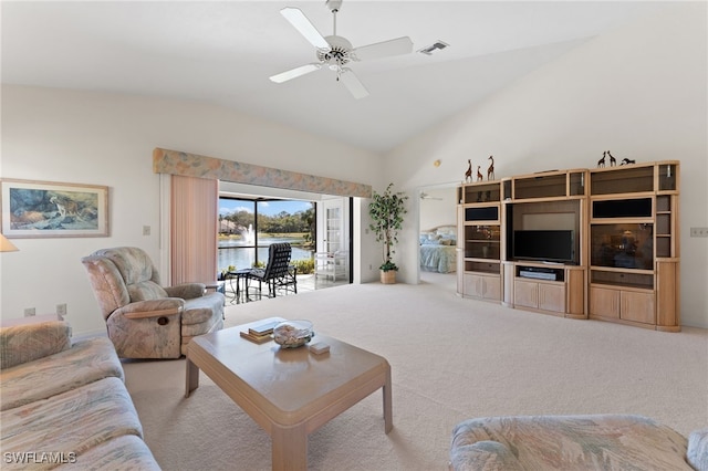 carpeted living room with vaulted ceiling and ceiling fan