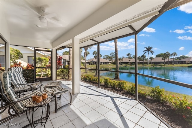 unfurnished sunroom with a water view and ceiling fan