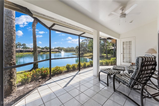 sunroom / solarium featuring a water view, a healthy amount of sunlight, lofted ceiling, and ceiling fan