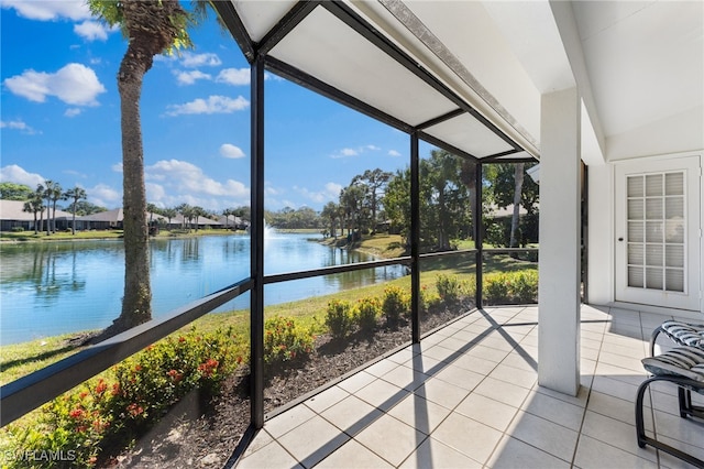 sunroom with plenty of natural light and a water view