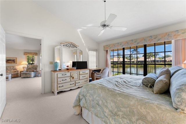 carpeted bedroom featuring ceiling fan, vaulted ceiling, and multiple windows