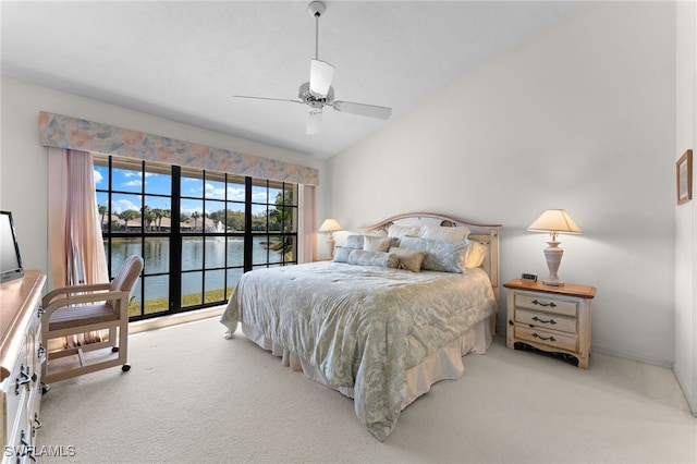 bedroom featuring a water view, light colored carpet, lofted ceiling, and ceiling fan