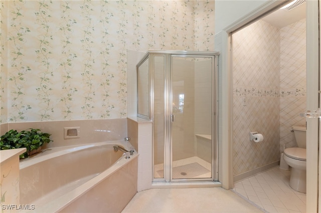 bathroom with tile patterned flooring, independent shower and bath, and toilet