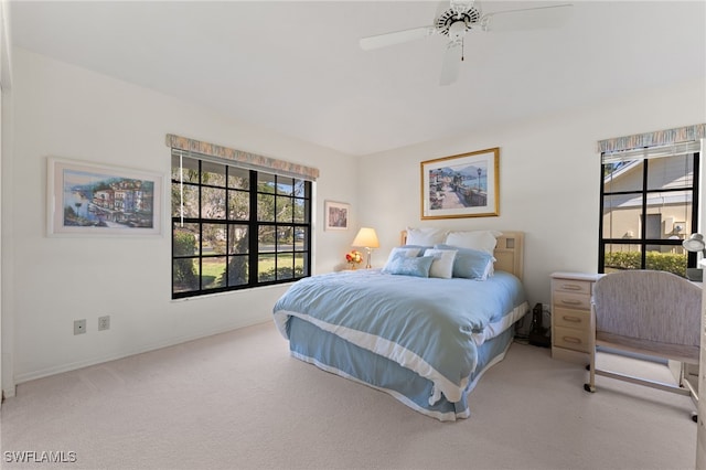 bedroom featuring ceiling fan, carpet, and multiple windows