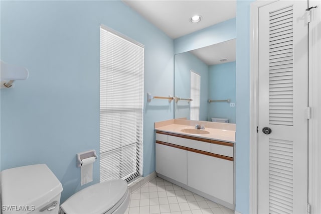 bathroom featuring vanity, tile patterned flooring, and toilet