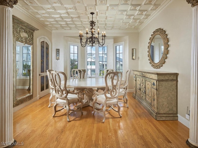 unfurnished dining area featuring ornamental molding, an inviting chandelier, and light wood-type flooring