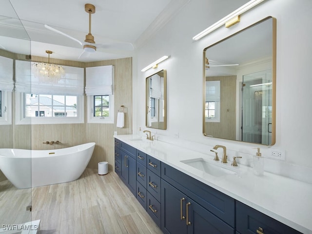 bathroom with hardwood / wood-style flooring, ornamental molding, independent shower and bath, and vanity