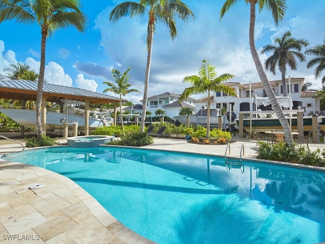 view of swimming pool with an in ground hot tub and a gazebo