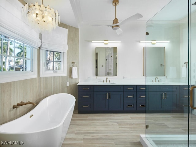 bathroom featuring vanity, crown molding, ceiling fan, and separate shower and tub