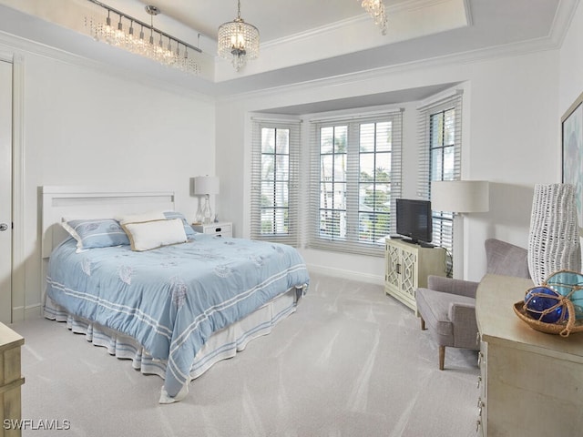 bedroom featuring ornamental molding, carpet floors, and a tray ceiling