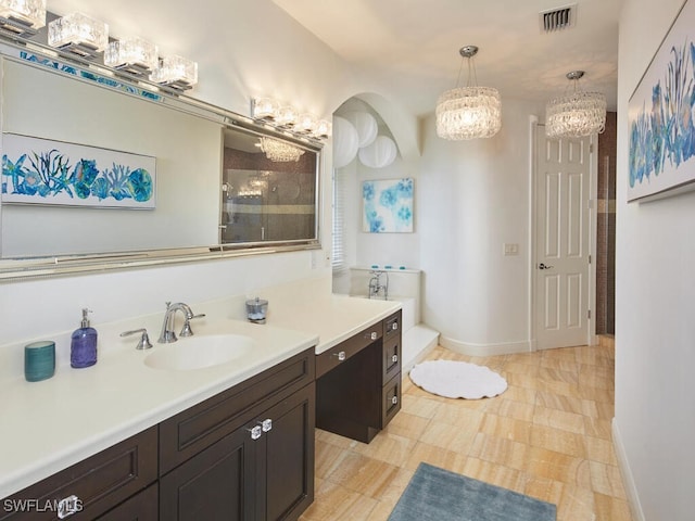 bathroom featuring vanity and tiled shower