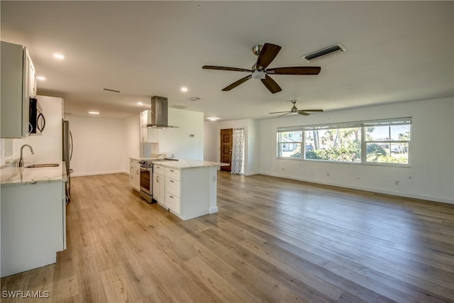 kitchen featuring ventilation hood, sink, white cabinets, stainless steel appliances, and light hardwood / wood-style flooring