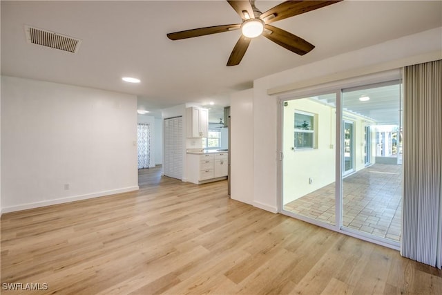 unfurnished living room featuring ceiling fan and light hardwood / wood-style flooring