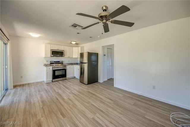 kitchen with ceiling fan, stainless steel appliances, light hardwood / wood-style flooring, and white cabinets