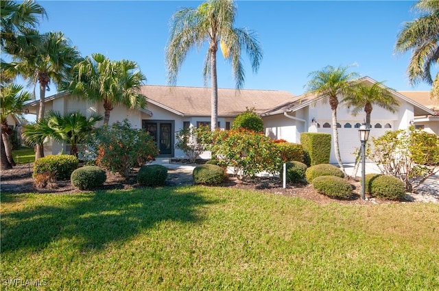 single story home with a garage, a front yard, and french doors