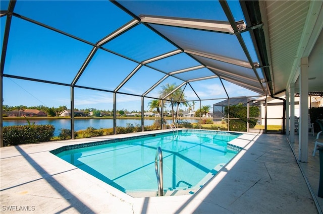 view of swimming pool with a water view, a patio area, and a lanai