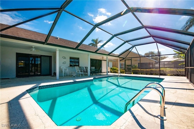 view of swimming pool featuring a patio, a lanai, and ceiling fan