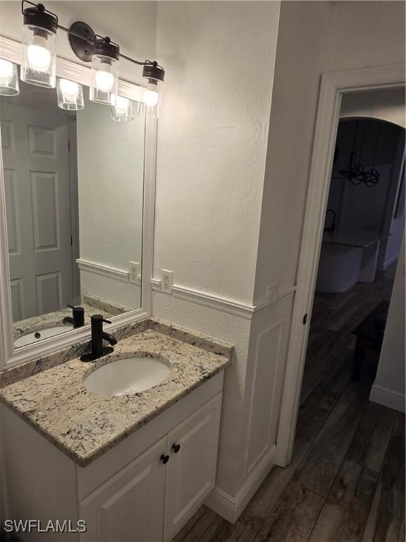 bathroom with vanity and hardwood / wood-style floors