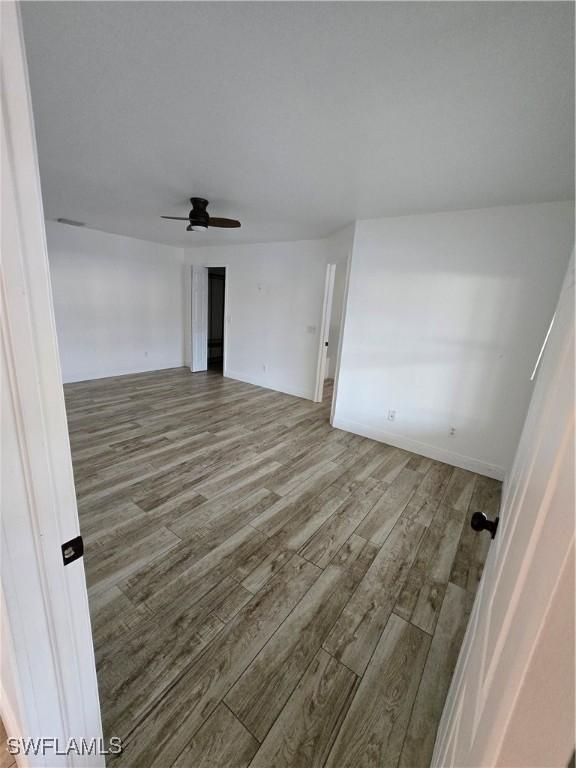 empty room featuring hardwood / wood-style floors and ceiling fan