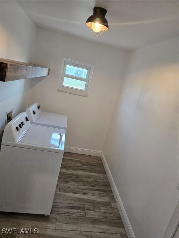 laundry area featuring dark hardwood / wood-style flooring and washer and dryer