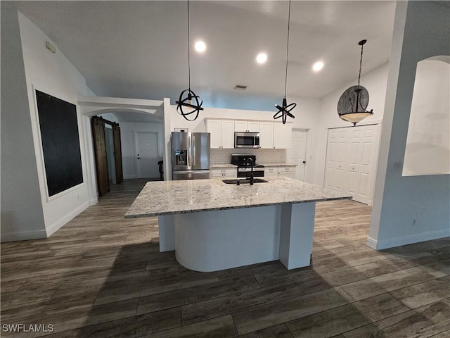 kitchen with pendant lighting, stainless steel appliances, sink, and white cabinets