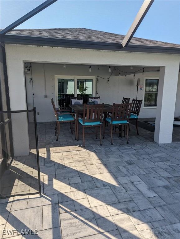 view of patio featuring a lanai