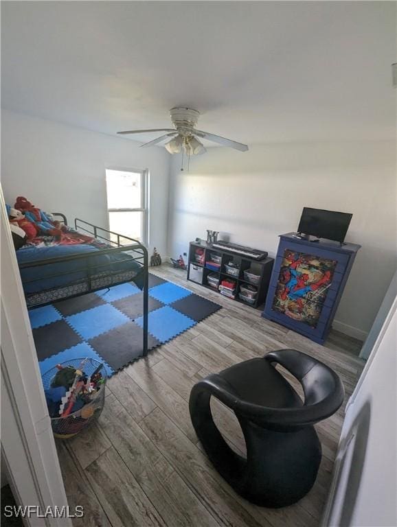 bedroom with hardwood / wood-style flooring and ceiling fan