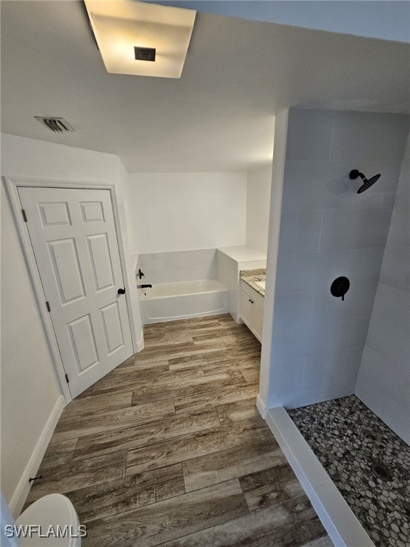 full bathroom featuring vanity, hardwood / wood-style flooring, independent shower and bath, and toilet