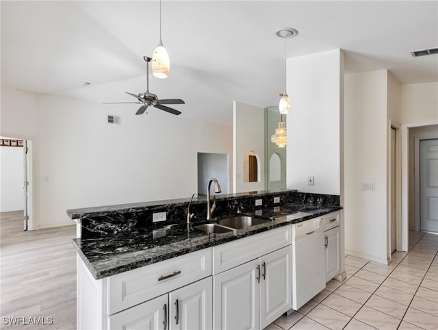 kitchen with sink, white cabinetry, white dishwasher, pendant lighting, and dark stone counters