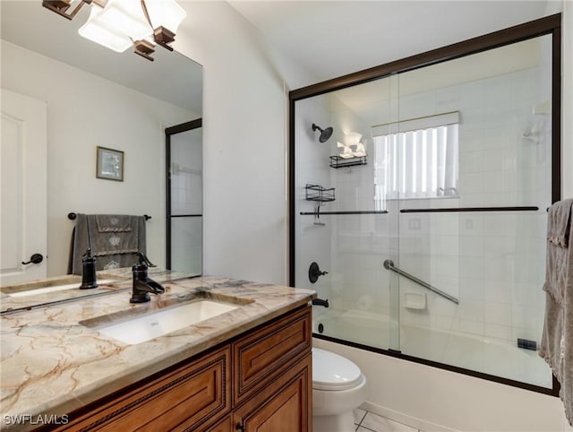 full bathroom featuring enclosed tub / shower combo, vanity, and toilet