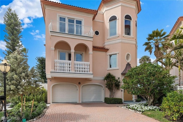 mediterranean / spanish home with a garage and a balcony