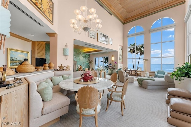 dining room with a water view, wood ceiling, an inviting chandelier, ornamental molding, and carpet