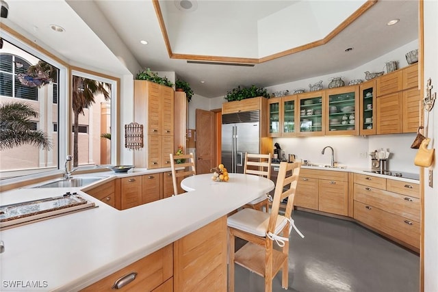 kitchen with sink, built in fridge, and concrete floors