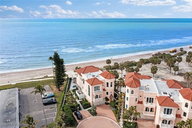 drone / aerial view featuring a water view and a view of the beach