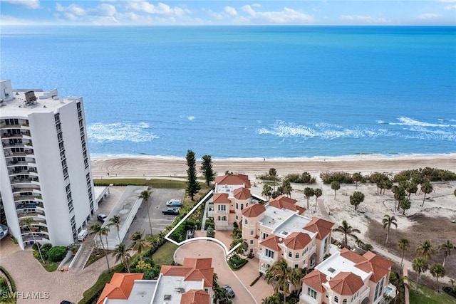 drone / aerial view with a water view and a beach view