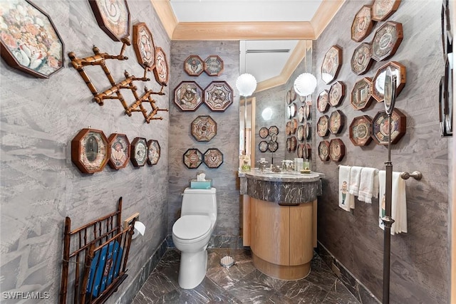 bathroom with ornamental molding, vanity, and toilet