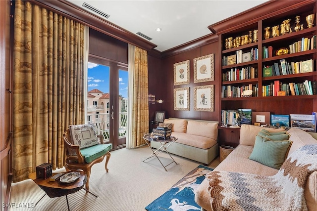 sitting room with light colored carpet and ornamental molding