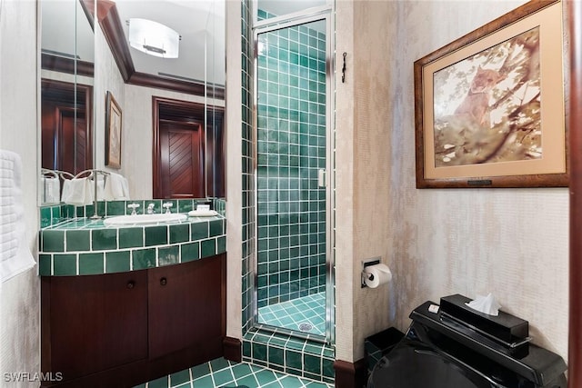 bathroom with crown molding, vanity, toilet, and a shower with door