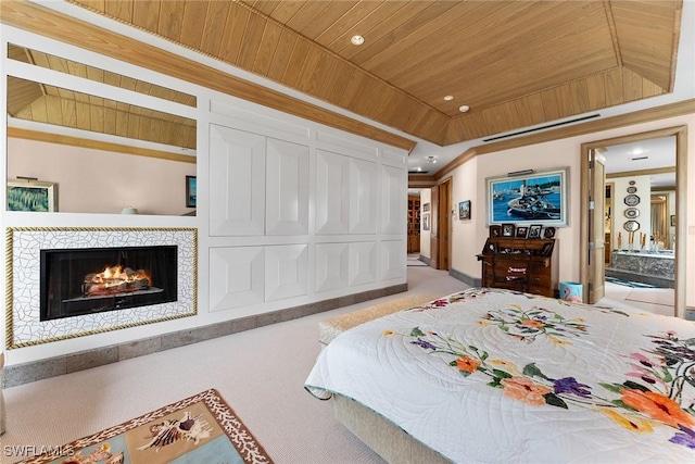 carpeted bedroom with crown molding, wooden ceiling, ensuite bath, and a tray ceiling