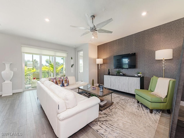 living room featuring ceiling fan and hardwood / wood-style floors