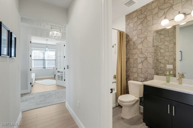 bathroom featuring vanity, hardwood / wood-style floors, curtained shower, and toilet