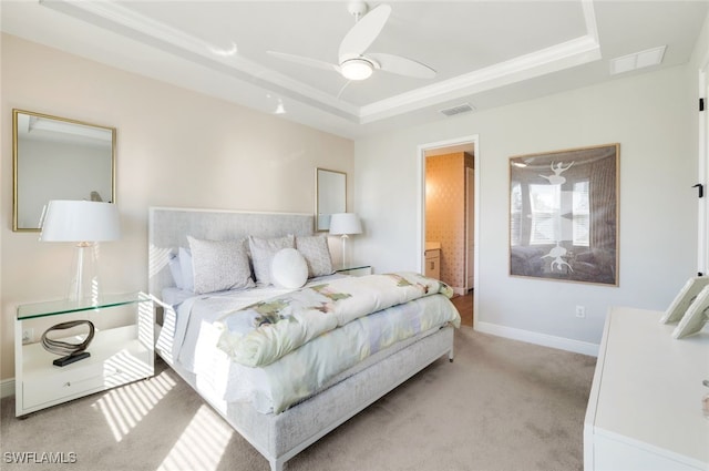 carpeted bedroom with connected bathroom, ceiling fan, and a tray ceiling