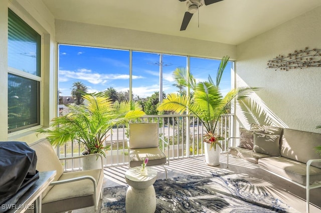 sunroom featuring ceiling fan