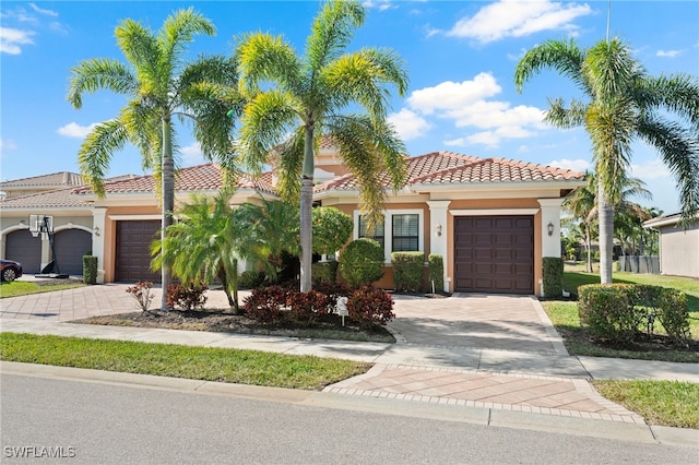 mediterranean / spanish-style house with a garage